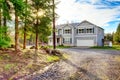 Two level blue country farm house with rocks trim