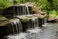 A two level man made stone waterfall cascading into a pond Royalty Free Stock Photo