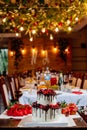 Two level white wedding cake, decorated with fresh red fruits and berries, drenched in chocolate. Bright banquet table decoration Royalty Free Stock Photo