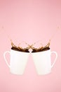 Two levitating coffee mugs with splashes. Coffee concept. Minima Royalty Free Stock Photo