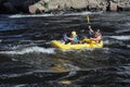 Two in life jackets and helmets rowing boat