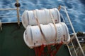 Two Liferafts secured with white straps in the red cradle on the cargo container ship Royalty Free Stock Photo