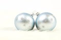 Two light blue and silver christmas balls on white fur background Royalty Free Stock Photo