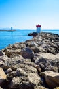 Two lighthouses located on the rocks of the breakwaters that protect the entrance to the marina