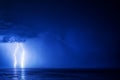 Two lightning bolts over the sea with a reflection Royalty Free Stock Photo