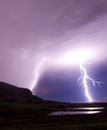 Two lightning bolts reflecting in water Royalty Free Stock Photo