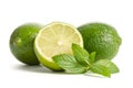 Two limes with half of a juicy lime with leaves of mint Royalty Free Stock Photo