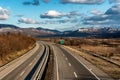 Two line wide highway curve on a summer day