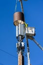 Two linemen up in the air installing 5G, new technology, wireless communications on a wood
