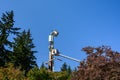 Two linemen working on a wireless communications radio and antenna installation using a bucket truck Royalty Free Stock Photo