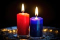 two lit candles of different colors signifying two religions in marriage Royalty Free Stock Photo