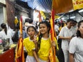 Two littel girl in yellow shirt hold flag