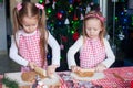 Two little adorable girls make gingerbread cookies Royalty Free Stock Photo