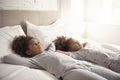 Two little african american girls on bed at home