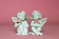 Two little angels holding roses