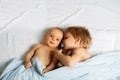 Boy murmur to little baby sister laying in the bed Royalty Free Stock Photo