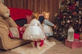 Two little babies in dresses with a christmas tree Royalty Free Stock Photo