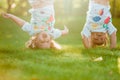 The two little baby girls hanging upside down