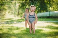 The two little baby girls playing with garden sprinkler. Royalty Free Stock Photo