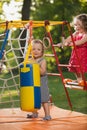 The two little baby girls playing at outdoor playground Royalty Free Stock Photo