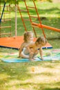 The two little baby girls playing at outdoor playground Royalty Free Stock Photo
