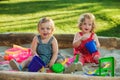 The two little baby girls playing toys in sand Royalty Free Stock Photo