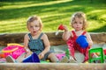 The two little baby girls playing toys in sand Royalty Free Stock Photo