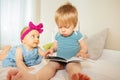 Baby boy read book to little infant girl Royalty Free Stock Photo