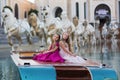 Two little beautiful girls in lush fashionable dresses sit on a boat on vacation. Girls posing Royalty Free Stock Photo