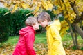 Two little best friends and kids boys autumn park in colorful clothes. Royalty Free Stock Photo