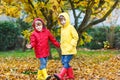 Two little best friends and kids boys autumn park in colorful clothes. Royalty Free Stock Photo