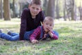 Two little blond brothers laying in grass in the spring Royalty Free Stock Photo