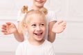Two little blond girls fooling around and play with each other Royalty Free Stock Photo