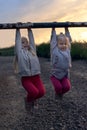 Two little girls, twins, having fun in the sunset