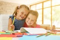 Portrait of two little girl drawing and looking at camera. Royalty Free Stock Photo