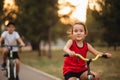 Two little boy and girl cyclists riding their bikes and enjoy having fun. Kid outdoors sport summer activity Royalty Free Stock Photo