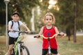 Two little boy and girl cyclists riding their bikes and enjoy having fun. Kid outdoors sport summer activity Royalty Free Stock Photo
