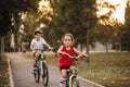 Two little boy and girl cyclists riding their bikes and enjoy having fun. Kid outdoors sport summer activity Royalty Free Stock Photo