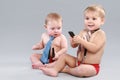Two Little boy in tie play with cell phone Royalty Free Stock Photo