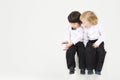 Two little boy on white cube play with wireless Royalty Free Stock Photo