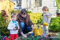 Two little boys and father planting seedlings in vegetable garden Royalty Free Stock Photo