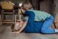 Two little boys fighting on the floor, brothers having fun at home. Concept of sibling relationship and brotherly love.