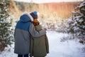 Two little boys friends hug each other in snowy winter forest. Brother love. Concept friendship. Back view