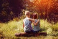 Two little boys friends hug each other in summer sunny day. Brother love. Concept friendship. Back view