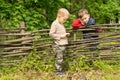 Two little boys having a discussion over a fence Royalty Free Stock Photo