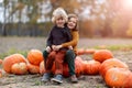 Two little boys having fun in a pumpkin patch