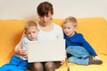 Two little boys and mother using laptop Royalty Free Stock Photo