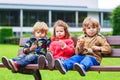 Two little boys and one girl eating chocolate Royalty Free Stock Photo