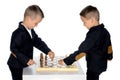 Two little boys play chess. Royalty Free Stock Photo