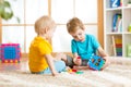 Two little boys play together with educational